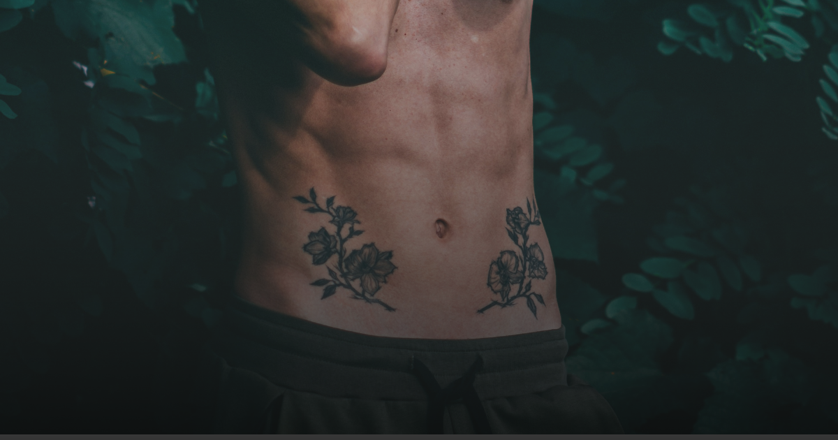 A Man Having Tattoo On Stomach